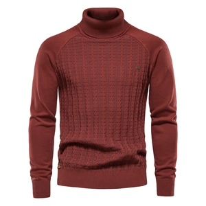 Macro view of cable knit pattern on burgundy turtleneck sweater showing high quality texture