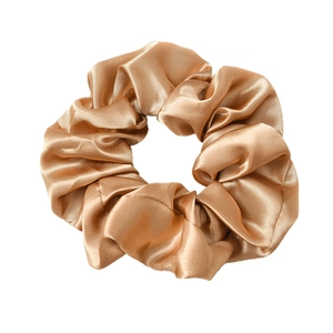 Champagne gold satin scrunchie with silky luster and elastic pleated design