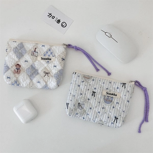 Detail of floral quilted cotton makeup bags with cute bear embroidery and purple zipper cords