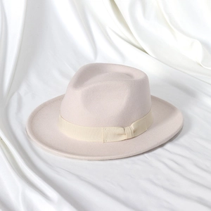 Detail of elegant wool felt fedora featuring a matching grosgrain ribbon and bow on satin