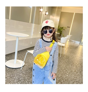 Close-up of kids yellow PVC chest bag with colorful sequins and adjustable strap