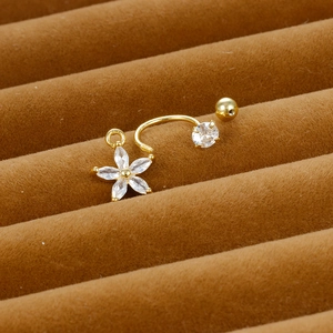 Macro detail of gold flower zircon belly ring with S925 engraving on velvet stand