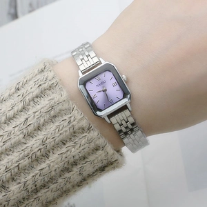 Elegant square purple dial quartz watch with silver steel strap on a woman's wrist