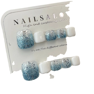Blue glitter and white gradient press-on toenails set on a professional display card