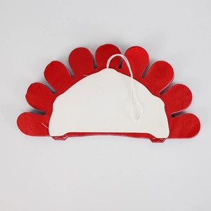 Detail of red petal-shaped felt ornament with white backing and hanging string