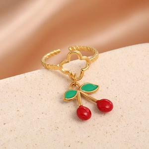 Adjustable cherry pendant ring with gold rope band and clover detail at 45-degree angle