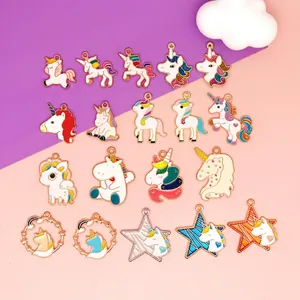 Colorful enamel unicorn and star alloy pendants for DIY jewelry making displayed on a paper background