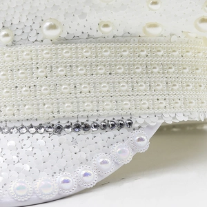 Close-up of luxury white bridal hat with sequins, woven pearls and sparkling rhinestones