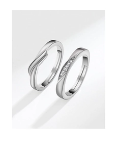 Macro detail of silver Mobius couple rings with sparkling pavé cubic zirconia