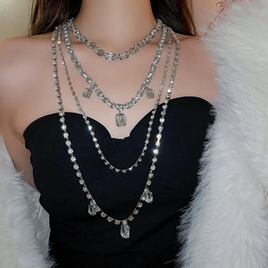 Macro detail of layered silver rhinestone choker with square crystal on model