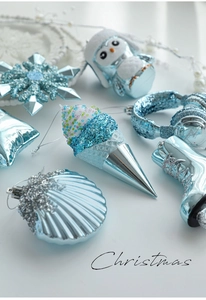Detailed view of light blue glitter Christmas ornaments in ice cream and owl shapes