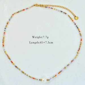 Detailed view of colorful beaded necklace with freshwater pearl and heart pendant