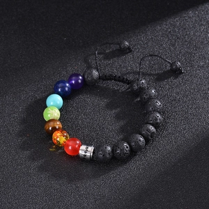 Macro shot of 10mm chakra beads and black lava stone bracelet with adjustable cord
