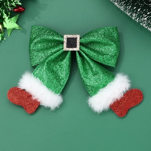 Detail of sequined Christmas stocking hair bow with festive belt buckle and fur trim