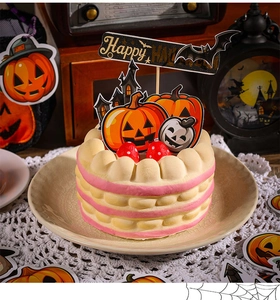 Detail view of Happy Halloween cake toppers set with pumpkin and haunted house designs