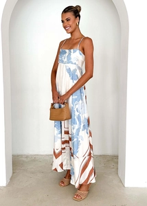 Detailed close-up of silky floral satin fabric on the white backless summer dress