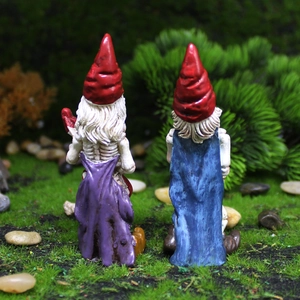 Rear view of musical skeleton garden gnomes set with guitars on a grassy lawn