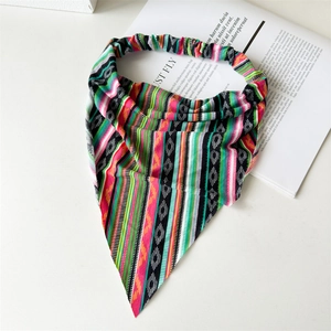 Detail of colorful geometric pattern headscarf with elastic band on a white surface