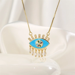 Detailed close-up of golden evil eye pendant with blue enamel and marquise-cut zircons