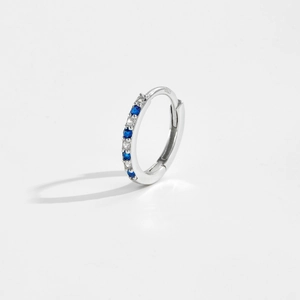 Detailed macro view of S925 sterling silver hoop earrings with blue and white zircon stones