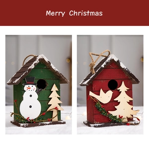 Detail of red and green wooden Christmas birdhouses with snowman and berry accents