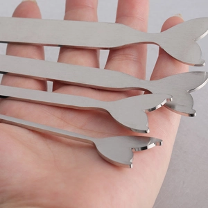 Detailed comparison of four stainless steel mermaid tail metal strips in hand for size scaling