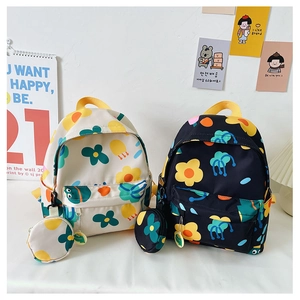 Detail of floral print kids backpacks in white and black with side coin pouches