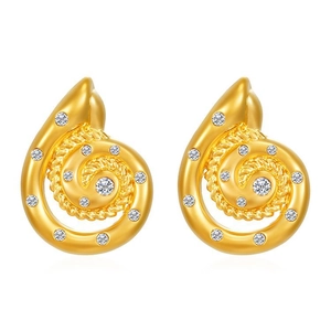 Macro shot of gold spiral conch earrings with sparkling cubic zirconia stones