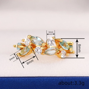Minimalist gold leaf ring with blue marquise stone and white cubic zirconia accents