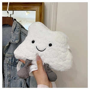 Detail shot of a white plush cloud-shaped crossbody bag with smiling face embroidery