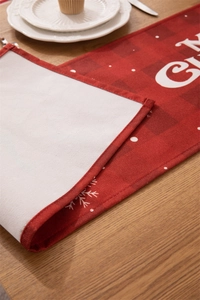Detail of red plaid Christmas table runner with white snowflakes and double-layer fabric