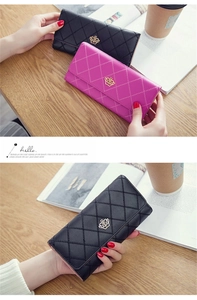 Close-up of diamond-quilted long wallets with golden crown logos in black and purple