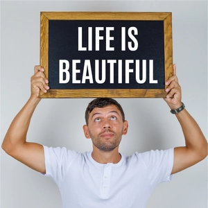 Close-up of small wooden framed chalkboard with artistic Life is Beautiful typography