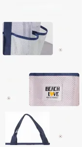 Close-up of mesh beach bag with reinforced navy blue handles and Beach Love logo patch