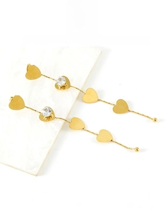 Detail view of 18K gold plated long tassel earrings with heart zircon and chain