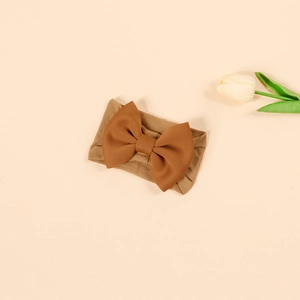 Detail of high-elasticity nylon baby headband featuring a large brown layered bow