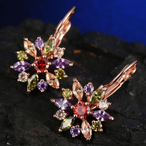 Macro shot of rose gold floral earrings with vibrant multi-color zircon stones