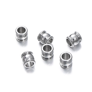 Close-up of silver cylindrical spacer beads with hollow design for DIY jewelry making