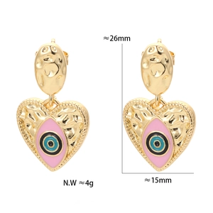 Macro shot showing dimensions 26x15mm and 4g weight of heart-shaped evil eye earrings