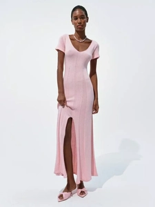 Detail view of pink short sleeve knitted dress with V-neckline and front side split