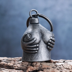 Detail of vintage silver double skull bell pendant with unique artistic texture