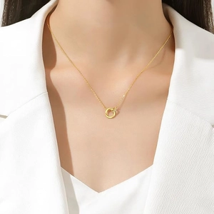 Elegant 18K gold Mobius necklace with sparkling zircon on a model wearing white suit