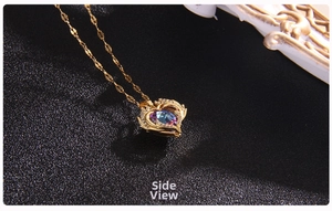 Macro side view of golden heart necklace with gradient purple crystal and pavé zircon stones