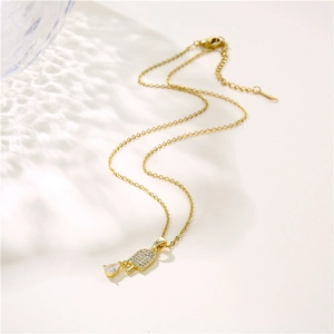 Golden ice cream pendant necklace with sparkling zircon crystals on white surface