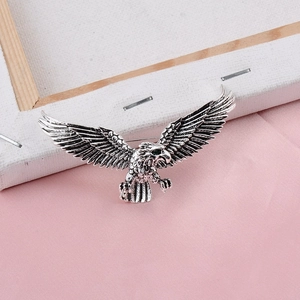 Fashion eagle brooch in vintage silver with green gemstone eye and feather details