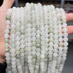 Macro shot of polished Tianshan green jade round beads for jewelry making and DIY crafts