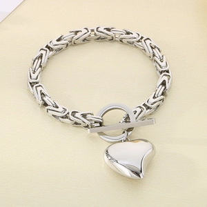 Detailed shot of silver Byzantine chain bracelet with heart charm and OT clasp