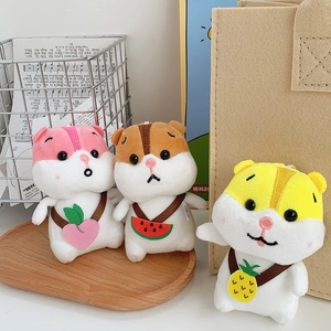 Close-up of cute plush hamster keychains with tiny fruit-shaped crossbody bags