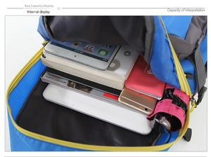 Detailed internal compartment of the travel backpack showing laptop, books, and umbrella
