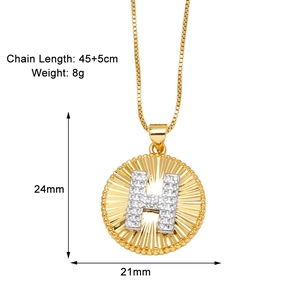 Detail view showing gold circular alphabet H necklace pendant with dimensions 24mm by 21mm